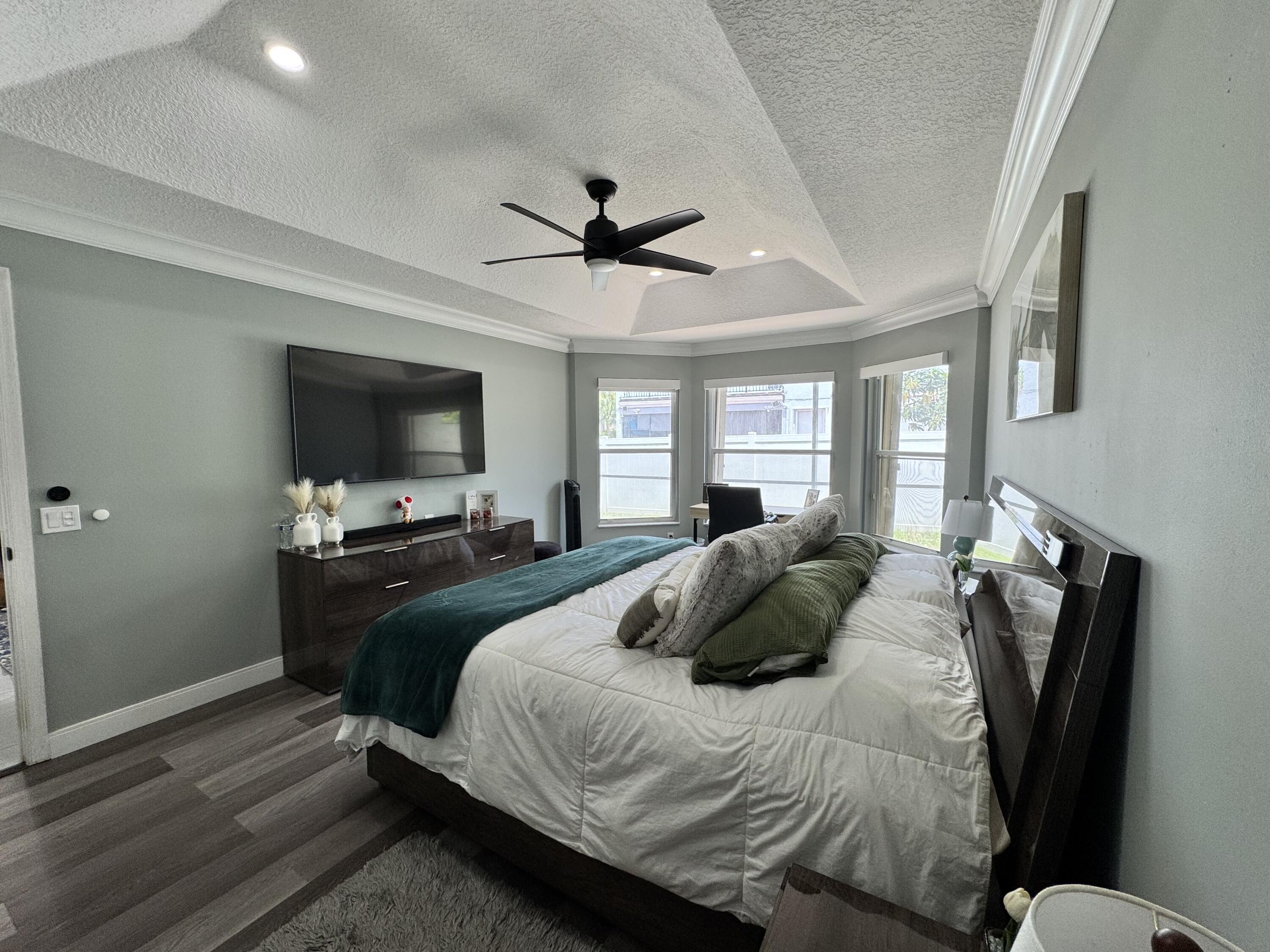 18038 Rhumba Way Boca Raton, FL 33496 - Photo 30 of 39 a bedroom with a bed and a flat screen tv