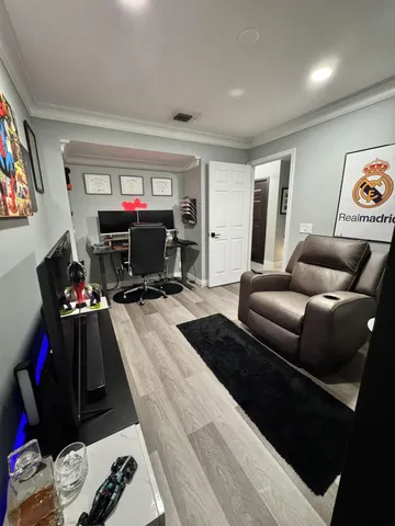 a bedroom with a large bed a couch and a window