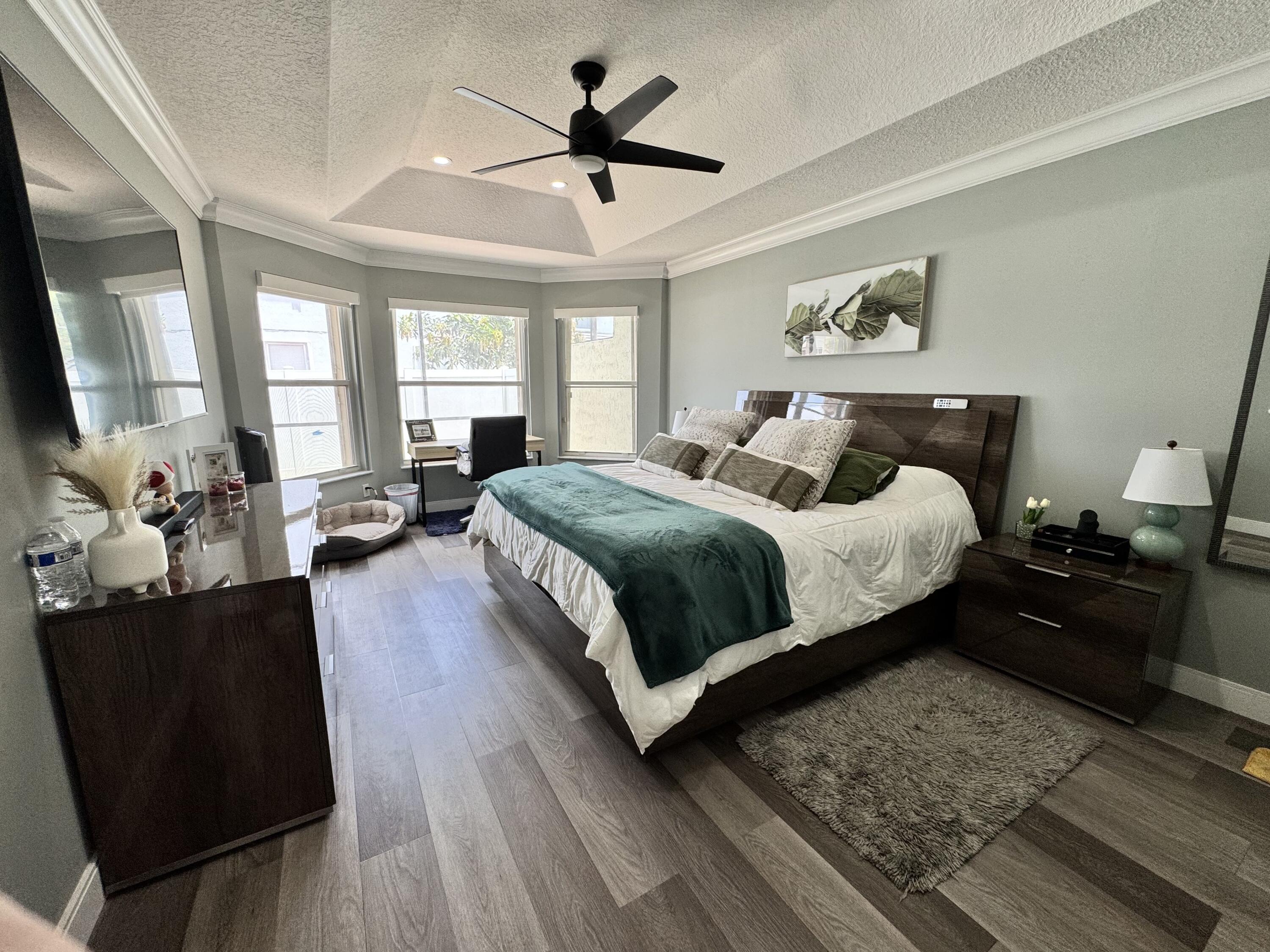 18038 Rhumba Way Boca Raton, FL 33496 - Photo 32 of 39 a bedroom with a large bed a couch and a window