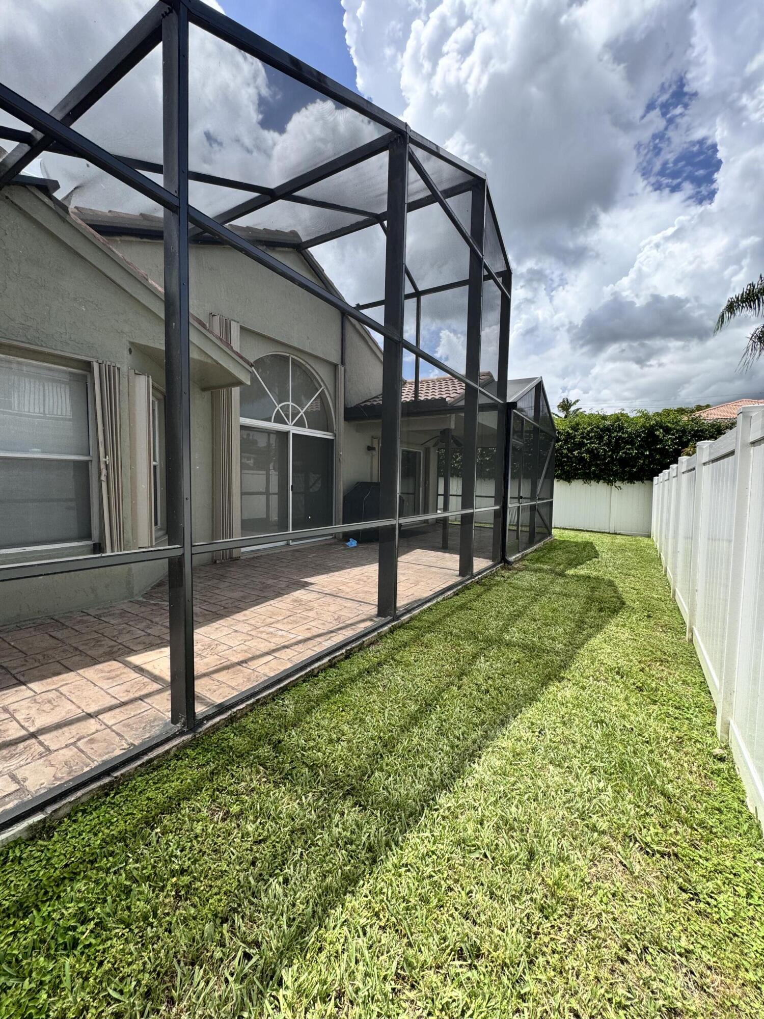 18038 Rhumba Way Boca Raton, FL 33496 - Photo 38 of 39 a view of tall building with a yard