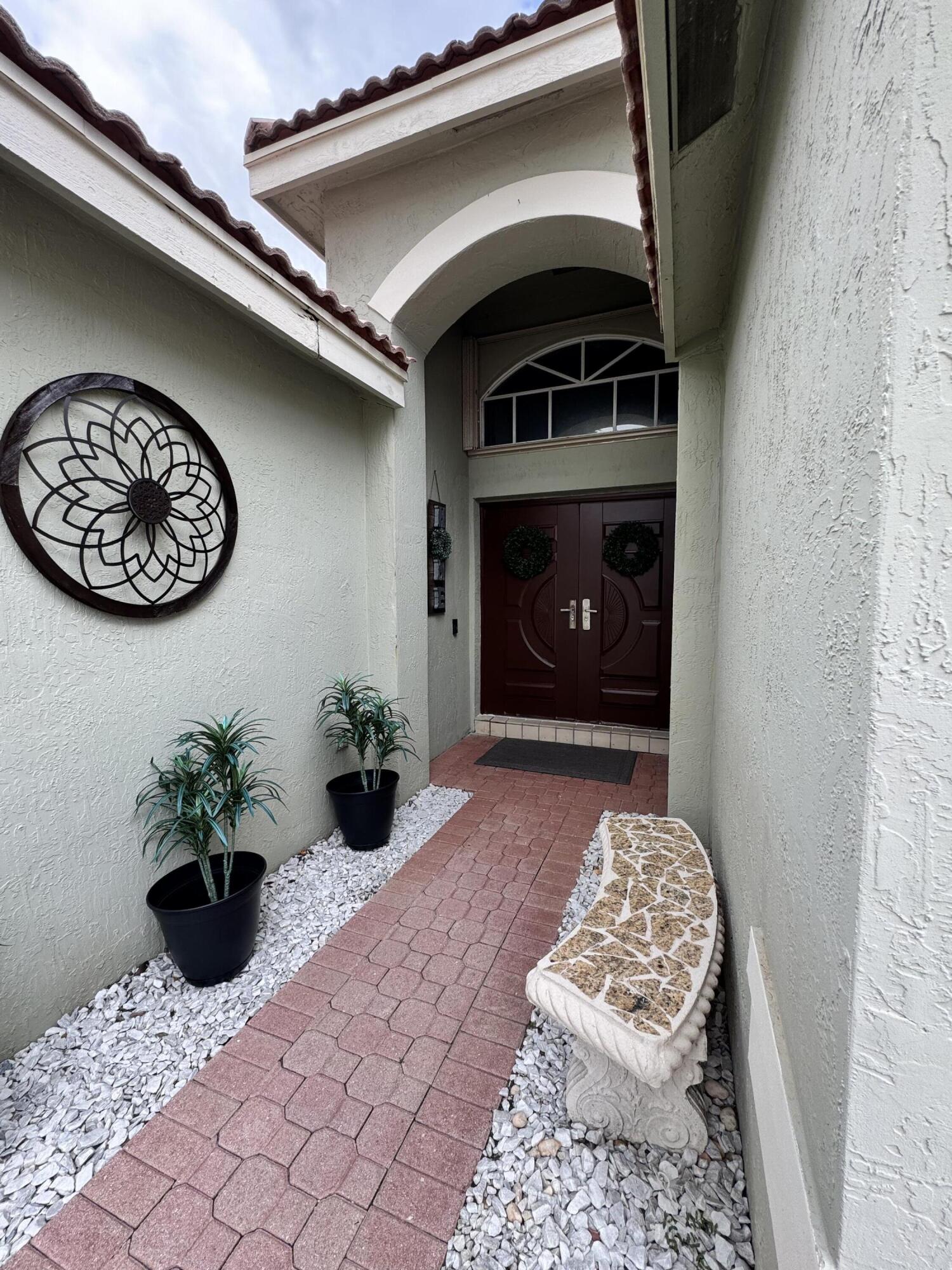 18038 Rhumba Way Boca Raton, FL 33496 - Photo 7 of 39 a view of a entryway door of the house
