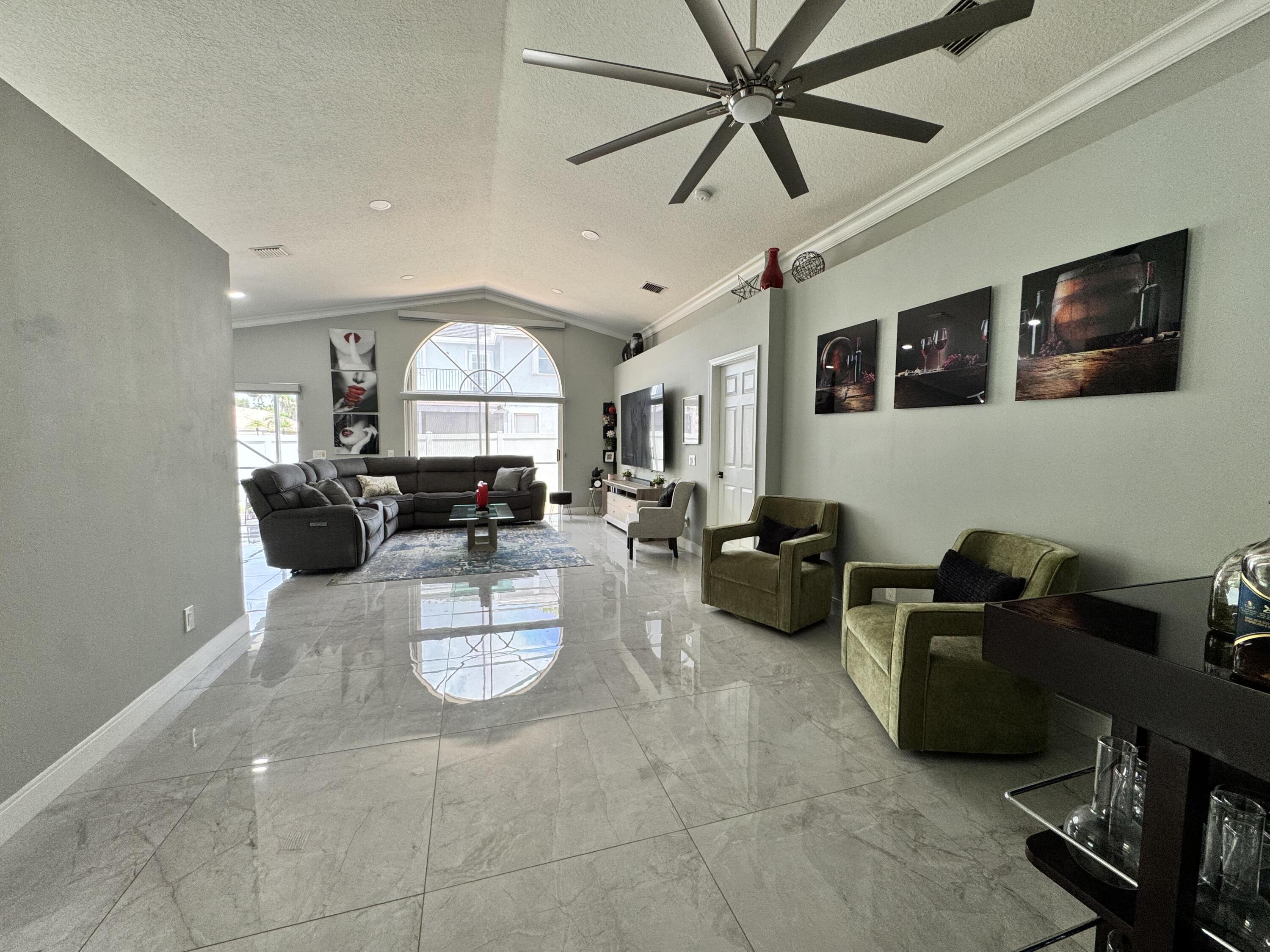 18038 Rhumba Way Boca Raton, FL 33496 - Photo 8 of 39 a living room with furniture and a flat screen tv