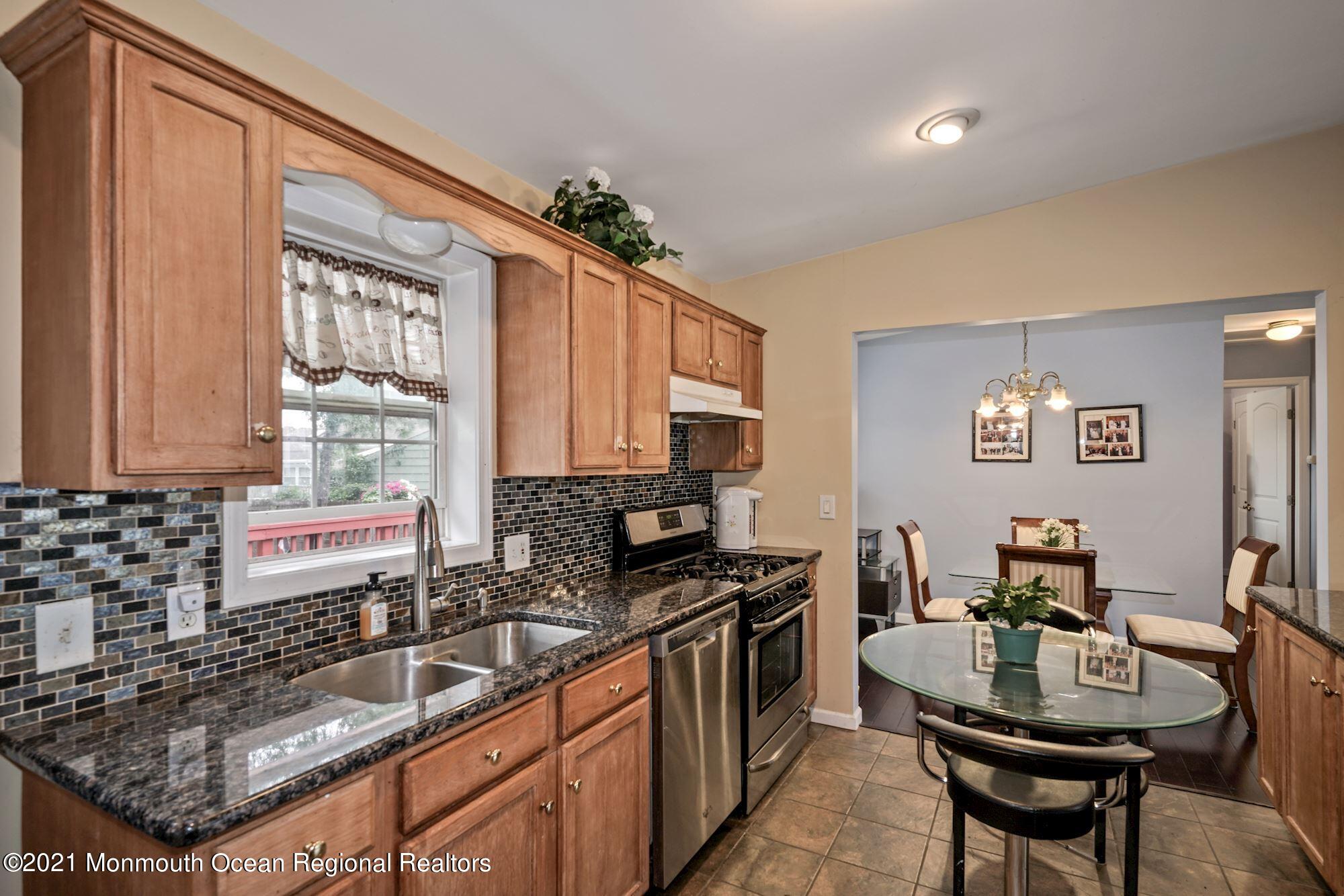 657 Drum Point Road Brick, NJ 08723 - Photo 2 of 25 a kitchen with granite countertop a sink stove and cabinets
