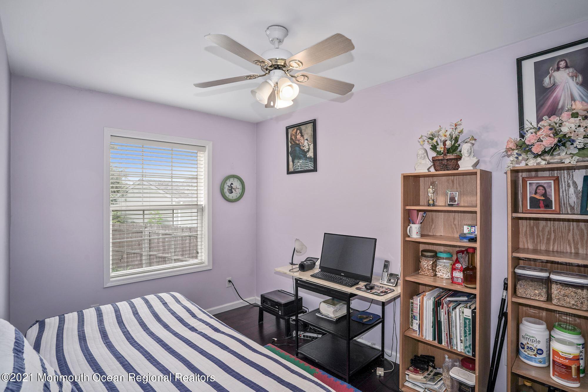 657 Drum Point Road Brick, NJ 08723 - Photo 14 of 25 a workspace with furniture and book shelf