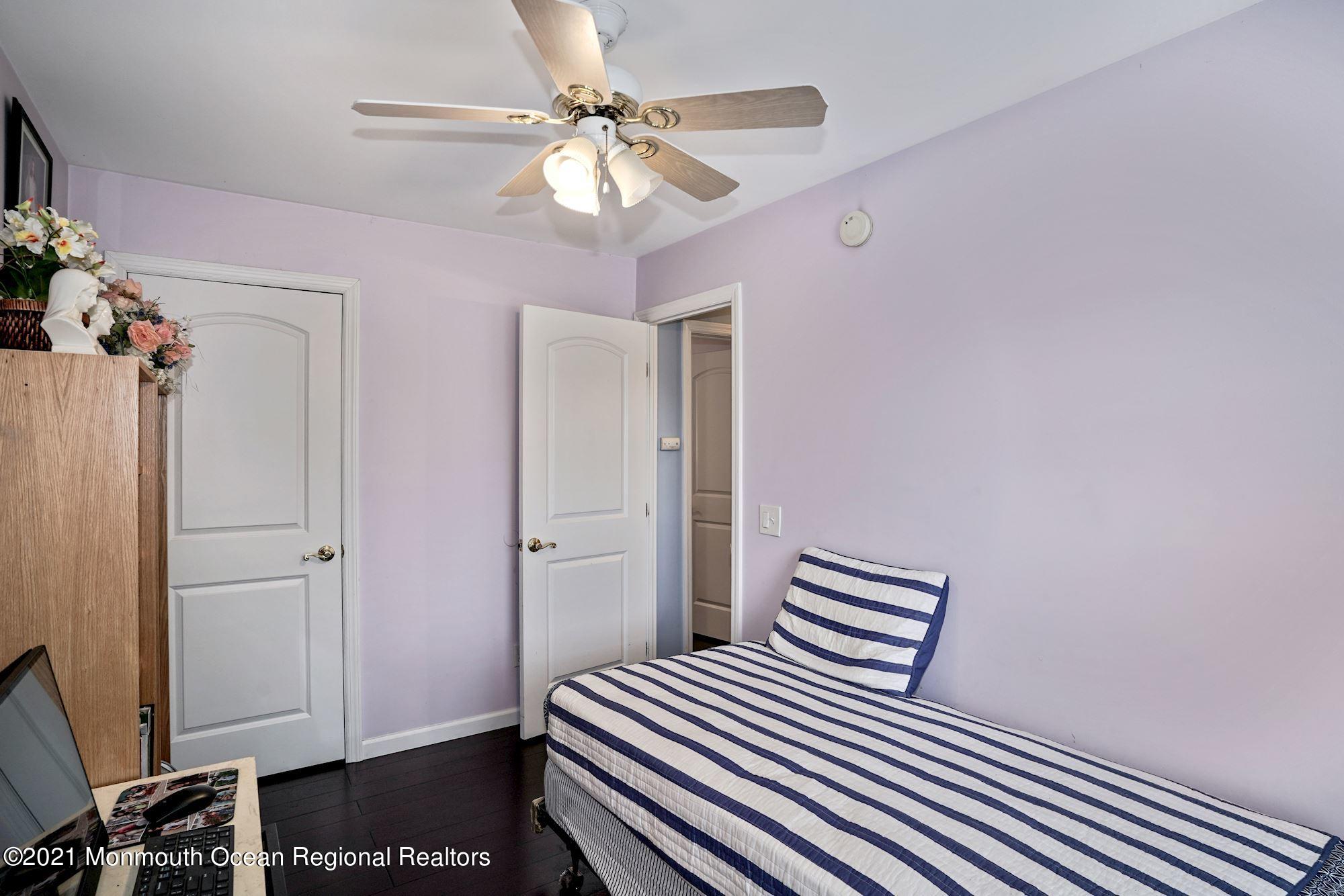 657 Drum Point Road Brick, NJ 08723 - Photo 16 of 25 a bedroom with a bed and a chandelier