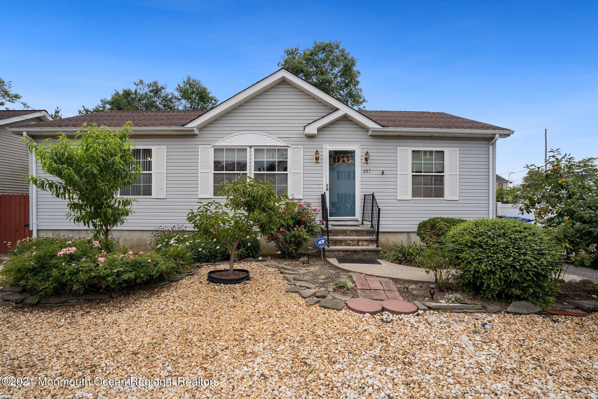 657 Drum Point Road Brick, NJ 08723 - Photo 20 of 25 a front view of a house with garden