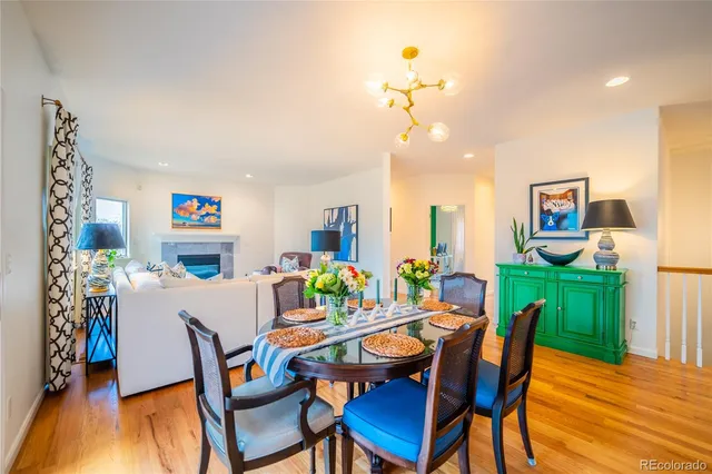 a view of a dining room with furniture a chandelier and wooden floor