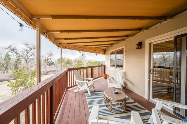 a view of a two chairs in the balcony