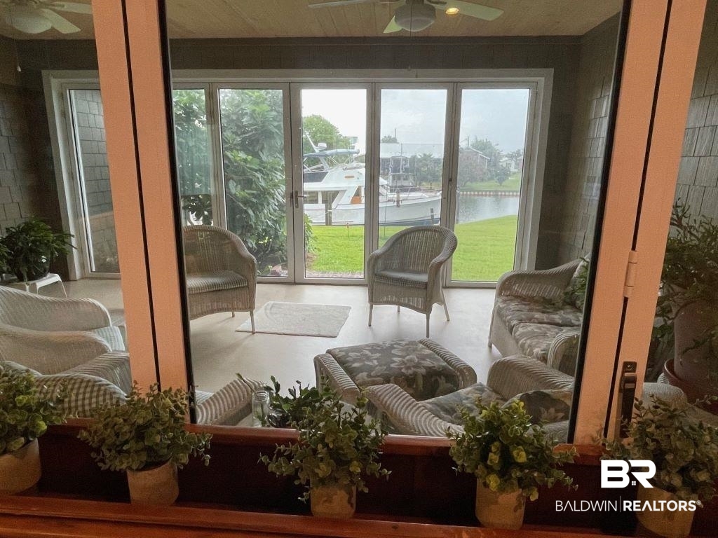 6426 East Quarry Drive Elberta, AL 36530 - Photo 14 of 19 Sunroom with a water view, ceiling fan, and a healthy amount of sunlight