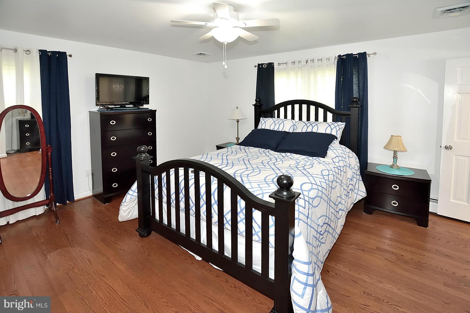 4902 Pole Road Alexandria, VA 22309 - Photo 14 of 30 a bedroom with a bed and a flat tv screen on dresser