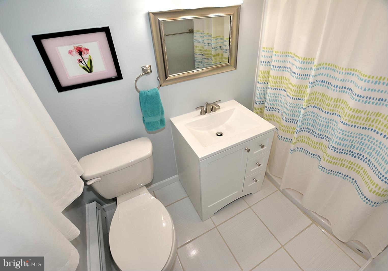 4902 Pole Road Alexandria, VA 22309 - Photo 15 of 30 a white toilet sitting next to a bathroom sink