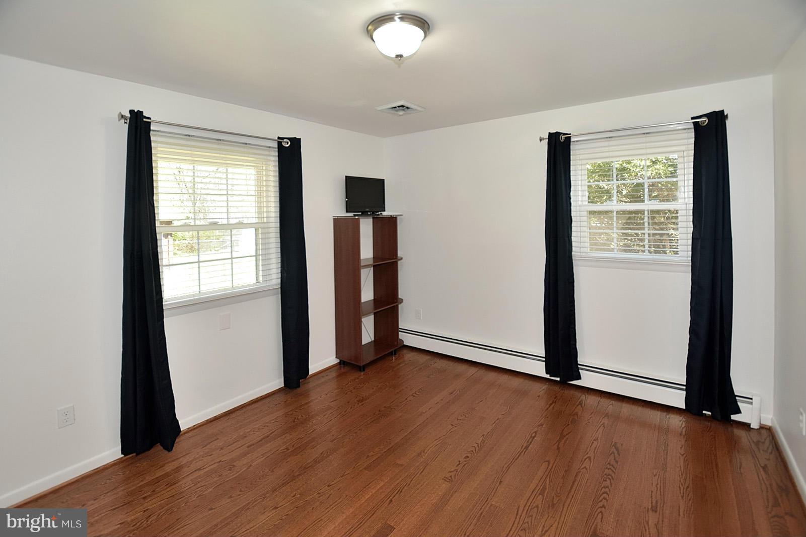 4902 Pole Road Alexandria, VA 22309 - Photo 17 of 30 a view of an empty room with window and wooden floor