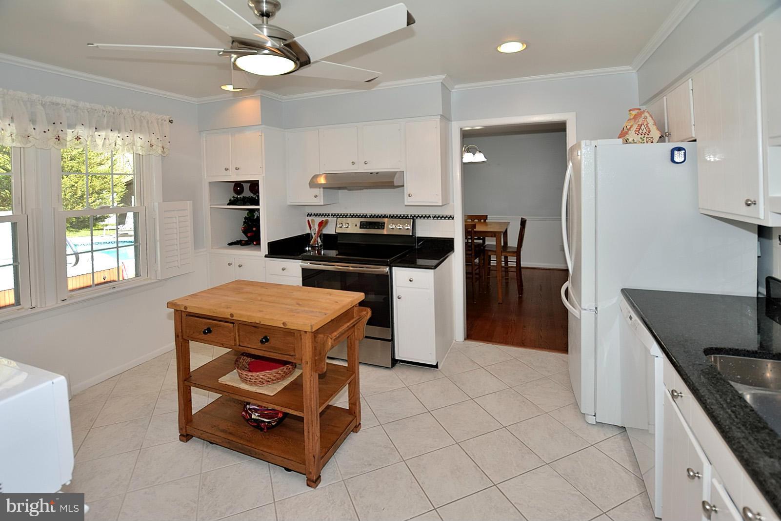 4902 Pole Road Alexandria, VA 22309 - Photo 7 of 30 a kitchen with stainless steel appliances granite countertop a stove a refrigerator a sink a stove and a refrigerator