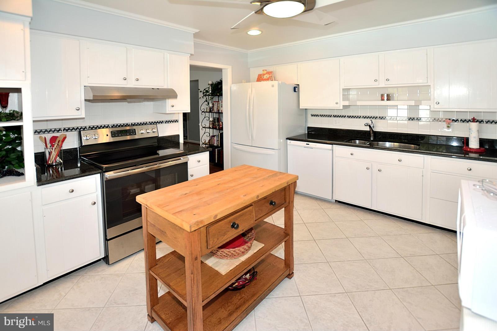 4902 Pole Road Alexandria, VA 22309 - Photo 8 of 30 a kitchen with stainless steel appliances granite countertop a stove a sink and a refrigerator
