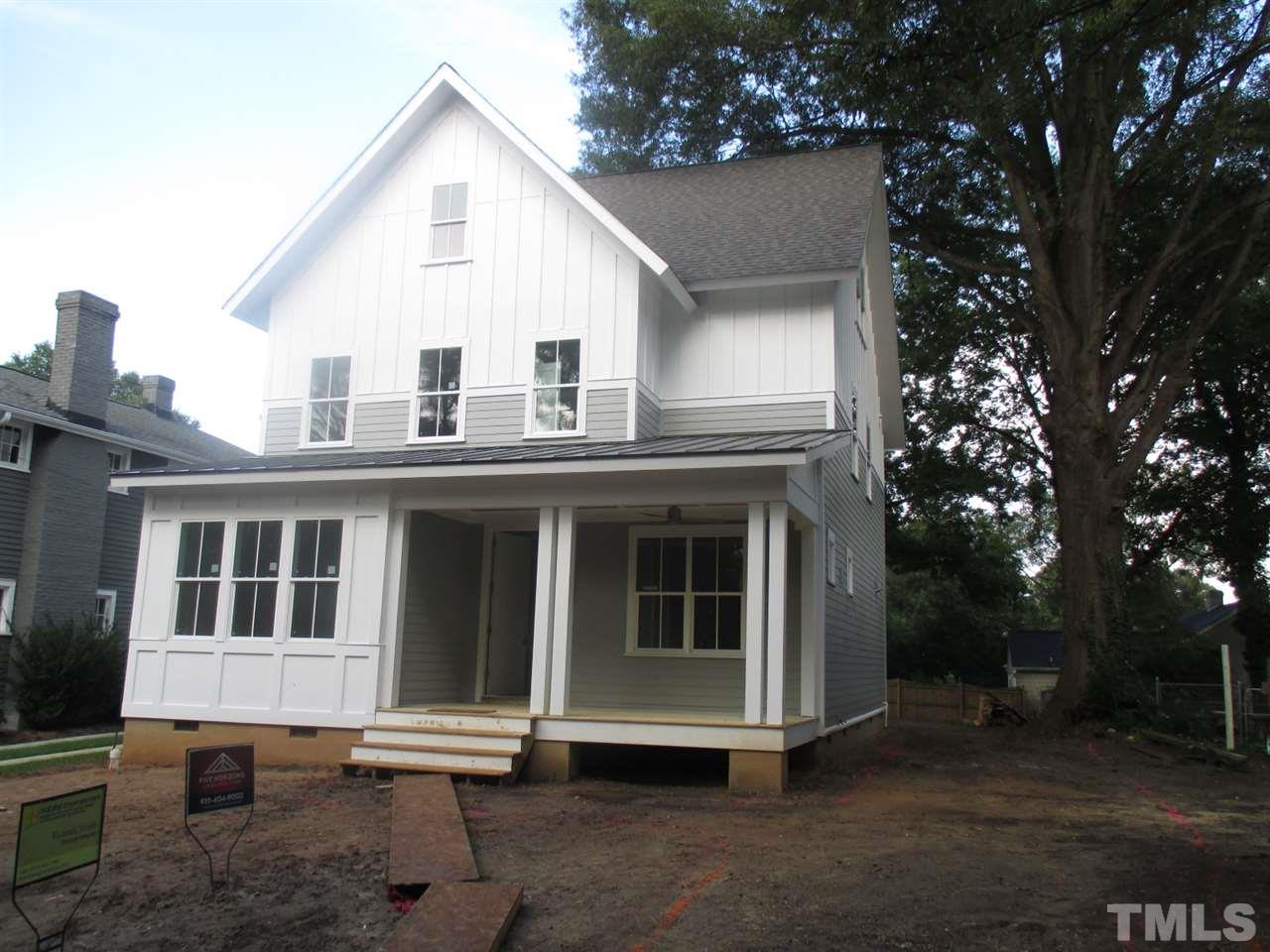 1104 Watauga Street Raleigh, NC 27604 - Photo 1 of 14 a view of a white house with large windows and a tree