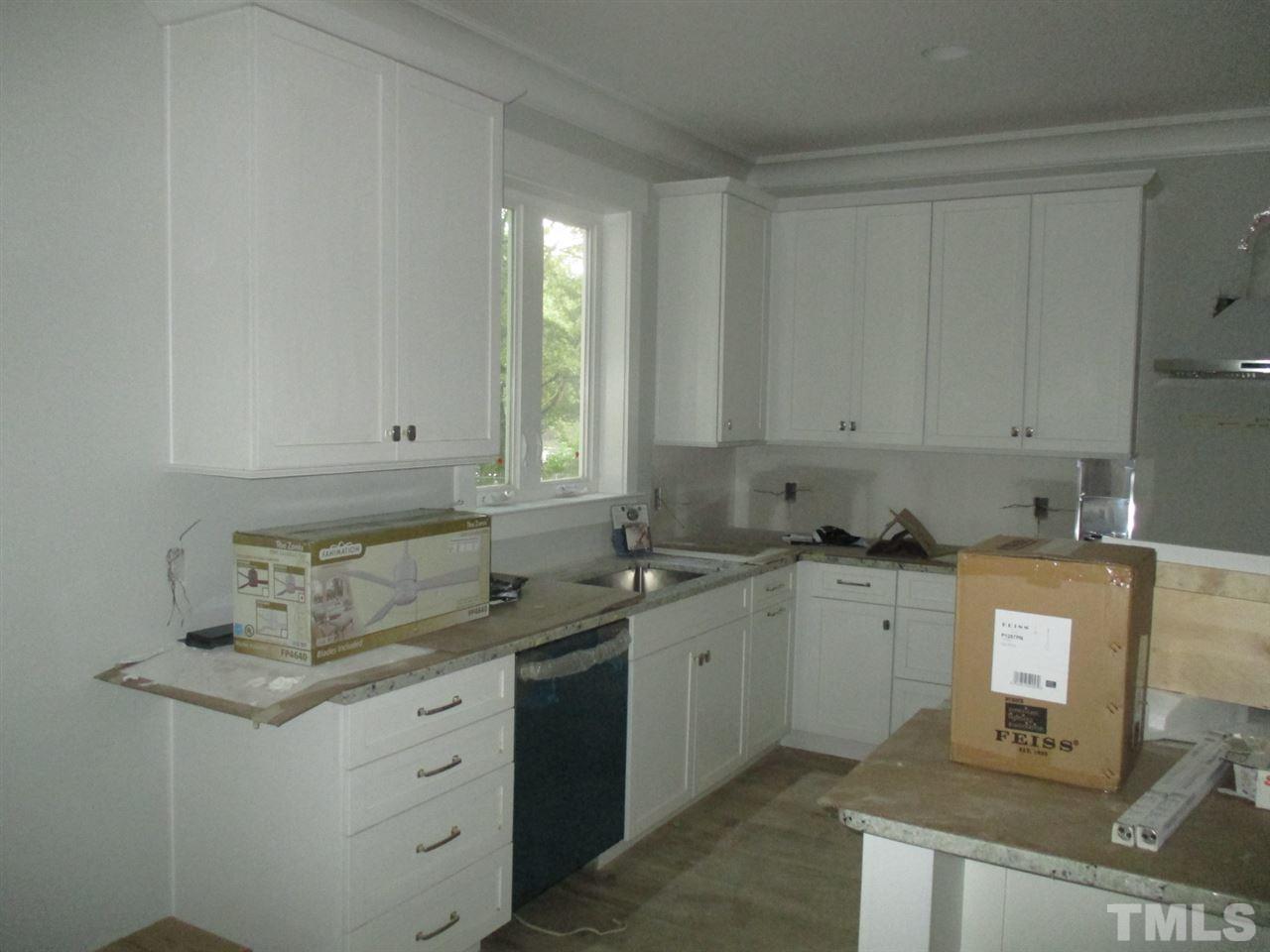 1104 Watauga Street Raleigh, NC 27604 - Photo 3 of 14 a kitchen with stainless steel appliances granite countertop a sink stove and cabinets
