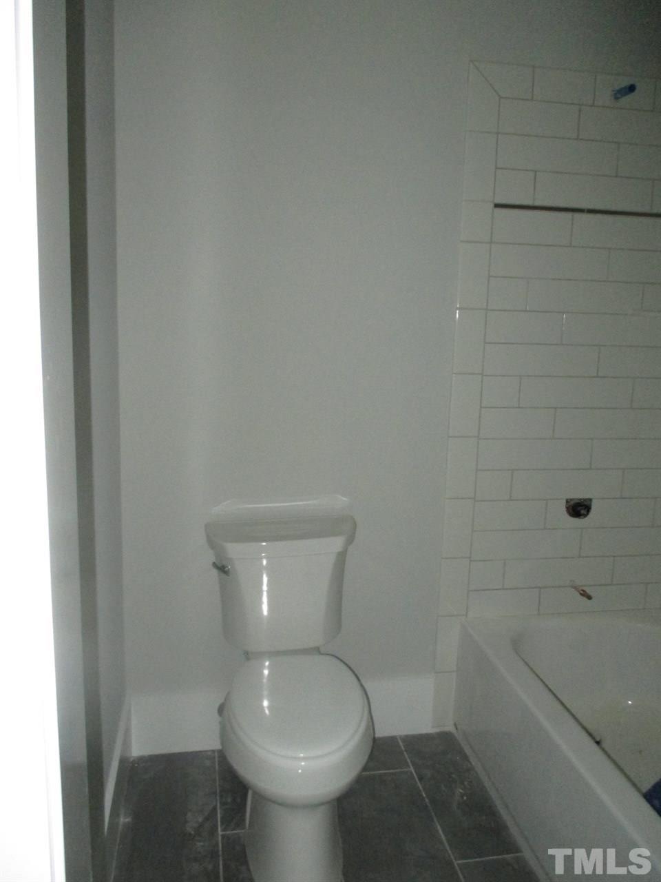1104 Watauga Street Raleigh, NC 27604 - Photo 10 of 14 a bathroom with a toilet and a shower