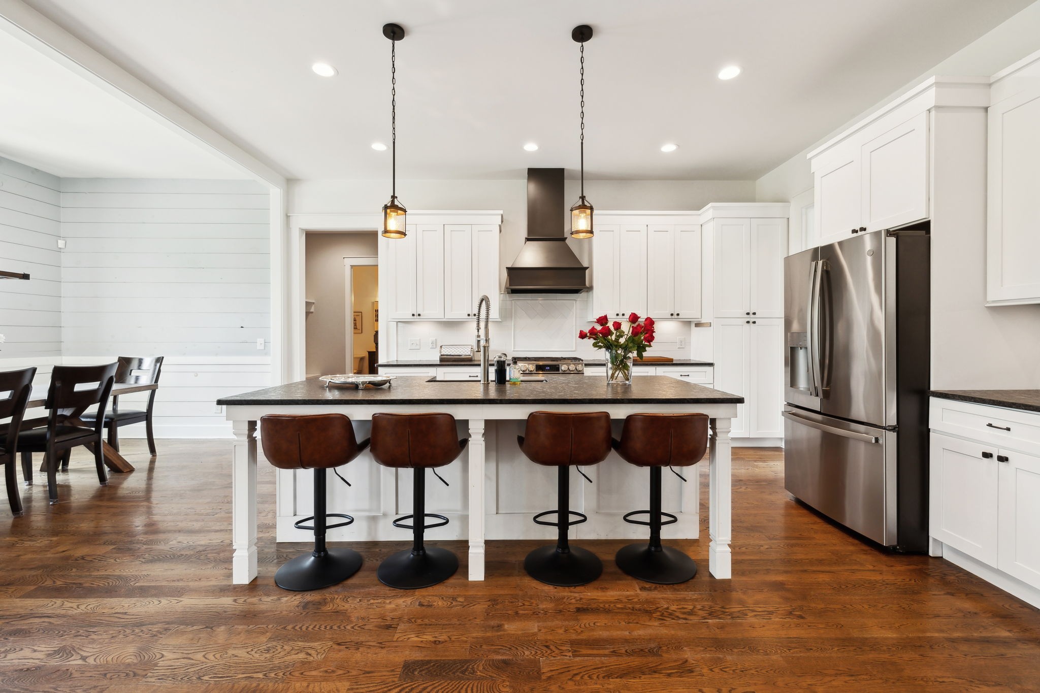 273 Halltown Road Cottontown, TN 37048 - Photo 13 of 65 a kitchen with stainless steel appliances kitchen island granite countertop a table chairs and a wooden floor