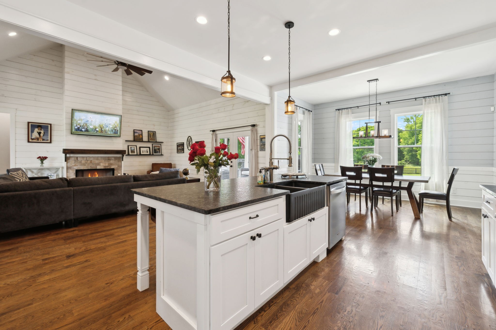 273 Halltown Road Cottontown, TN 37048 - Photo 16 of 65 a kitchen with stainless steel appliances granite countertop wooden cabinets a sink dishwasher a stove and a dining table with wooden floor