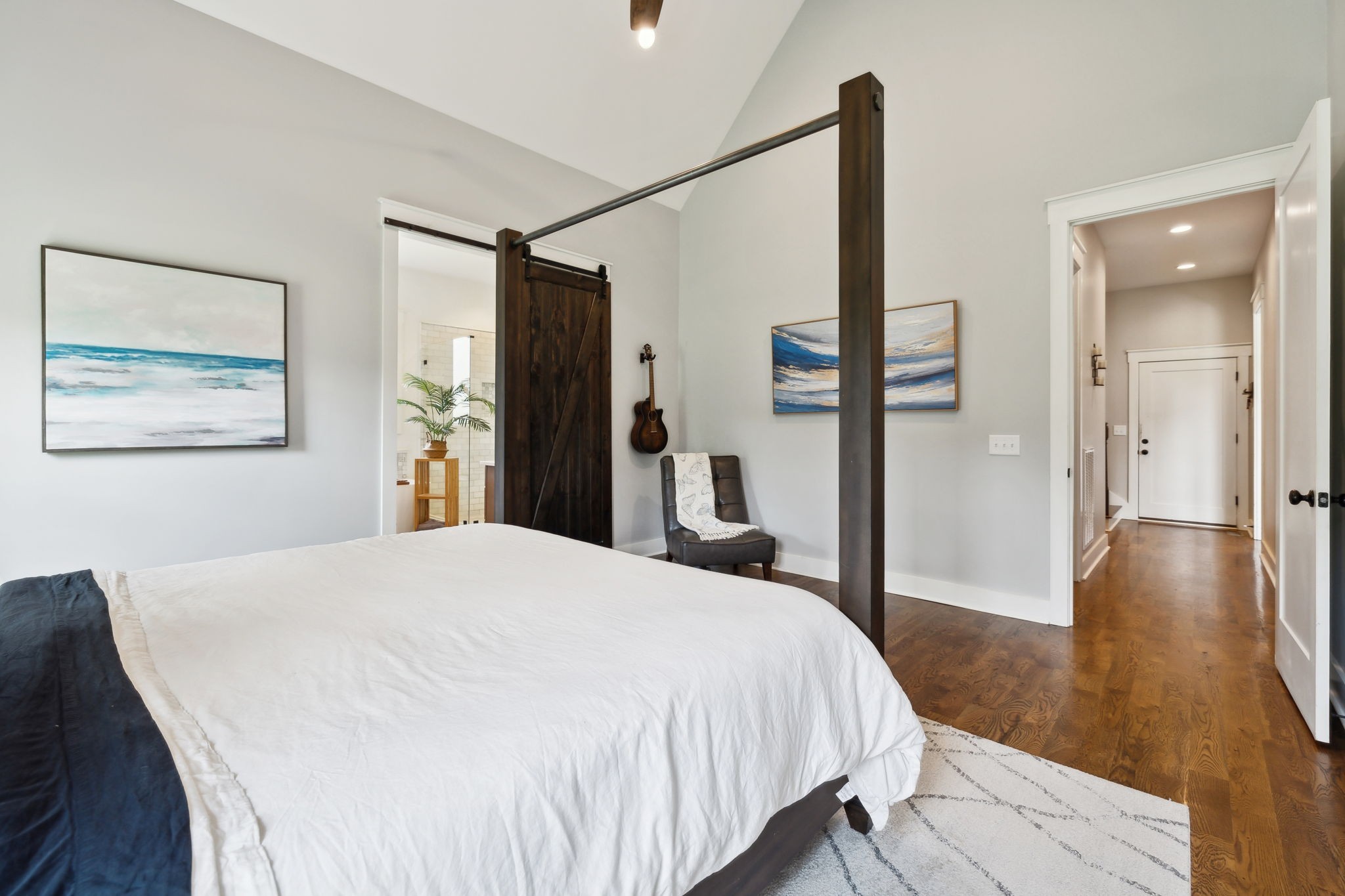 273 Halltown Road Cottontown, TN 37048 - Photo 34 of 65 a spacious bedroom with a bed and a dresser with wooden floor