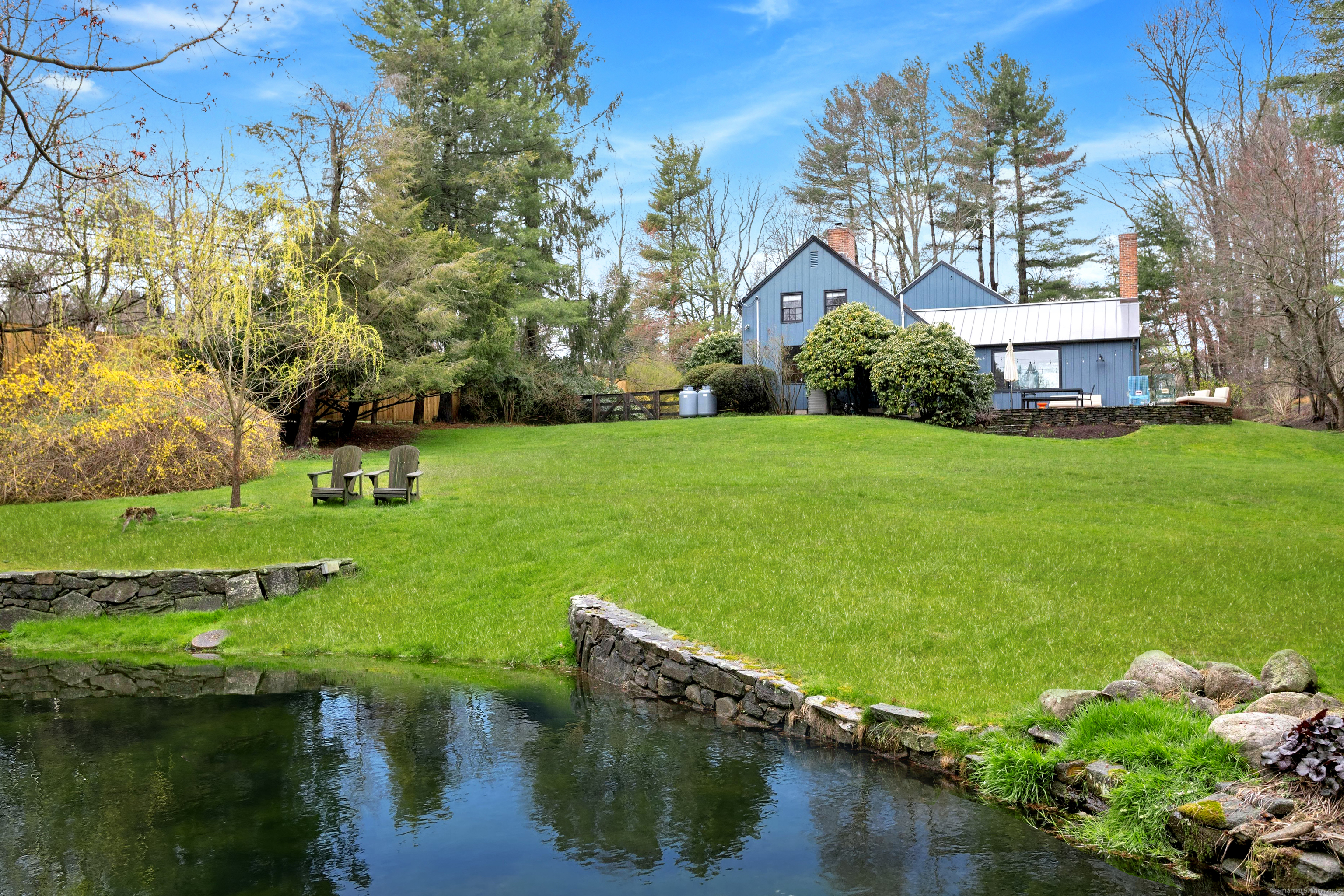 One acre of beautifully landscapped back yard to enjoy the peacefulness of your pond.