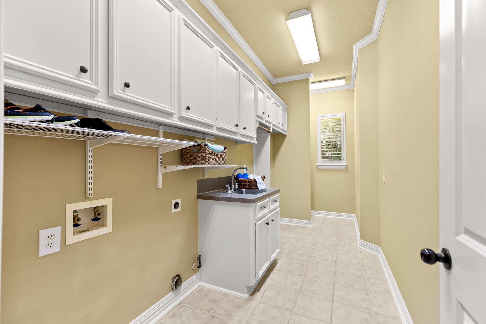 6610 Radley Drive Spring, TX 77379 - Photo 20 of 50 Laundry room large enough for washer/dryer and 2nd refrigerator. Floor-to-ceiling shelving at end near window.