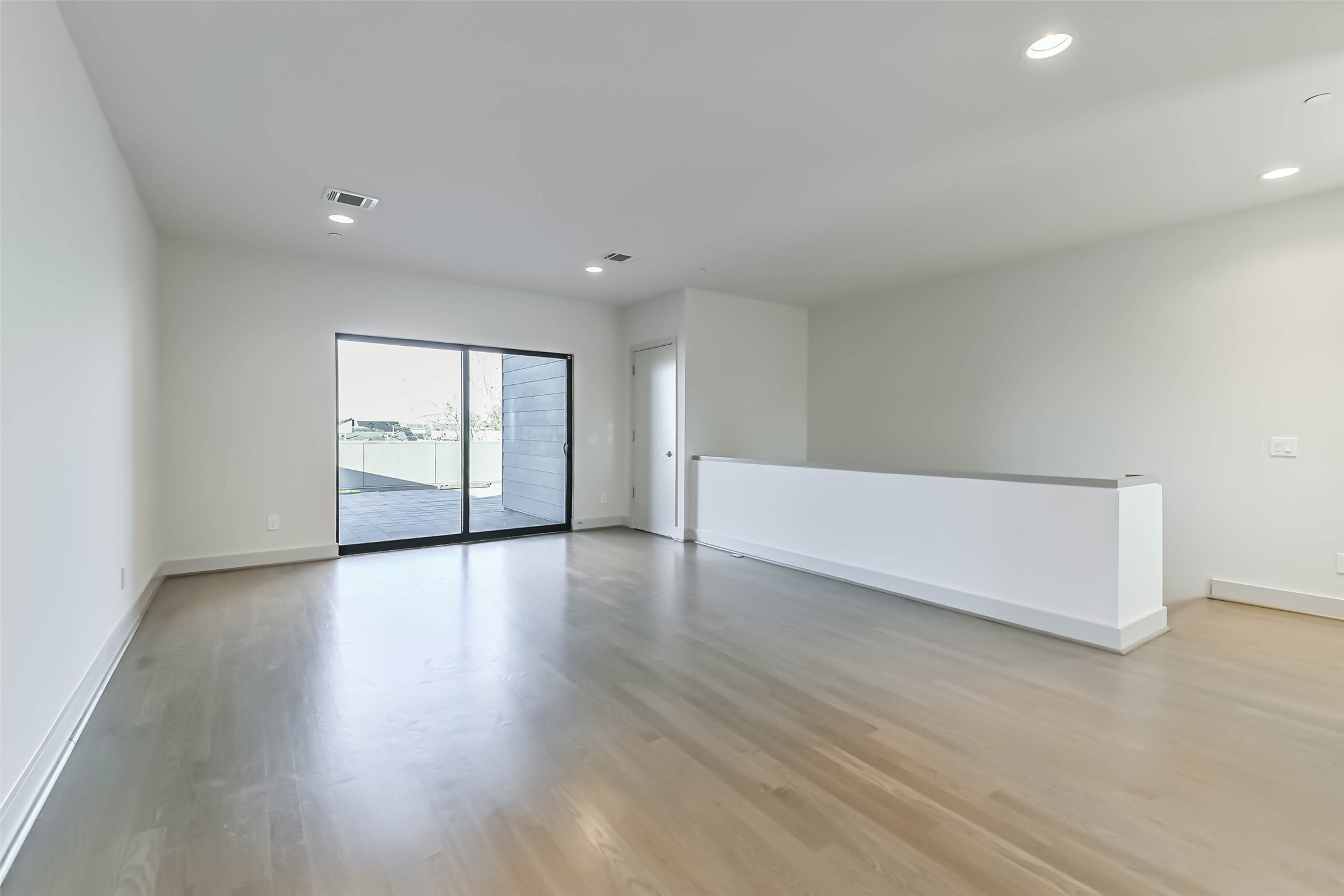 1509 Ruth Street Houston, TX 77004 - Photo 17 of 33 a view of an empty room with wooden floor and window