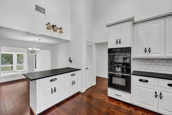 a kitchen with granite countertop a refrigerator and a stove