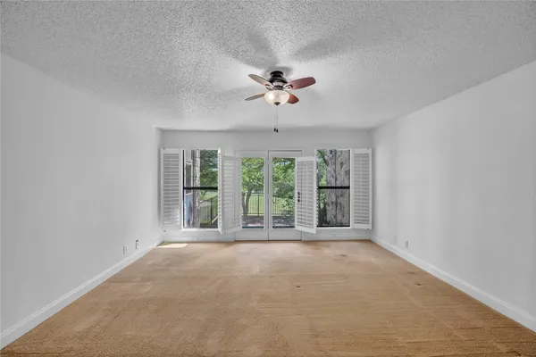 a view of an empty room with a window
