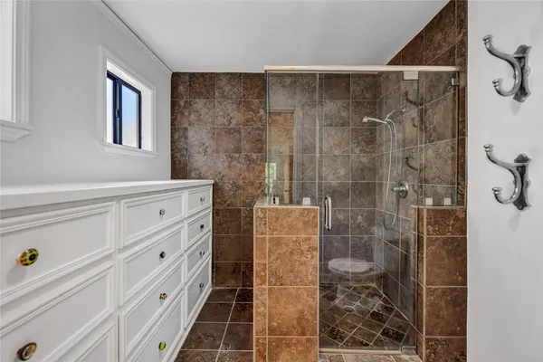 a bathroom with a shower toilet and a sink
