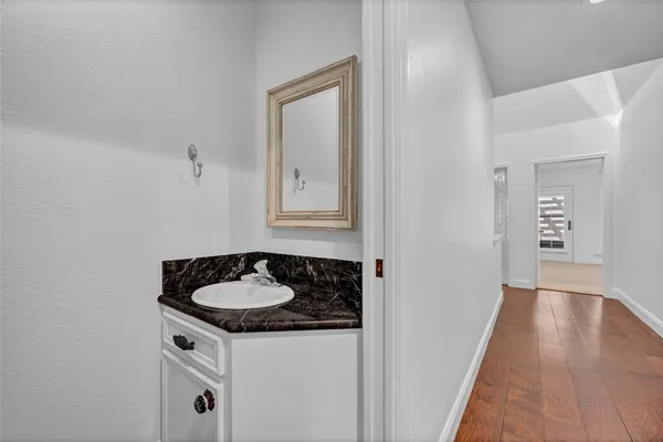 a bathroom with a granite countertop sink and vanity