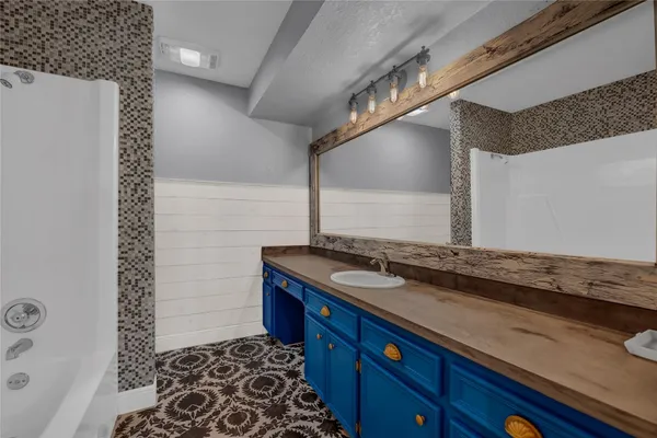 a bathroom with a sink and a mirror