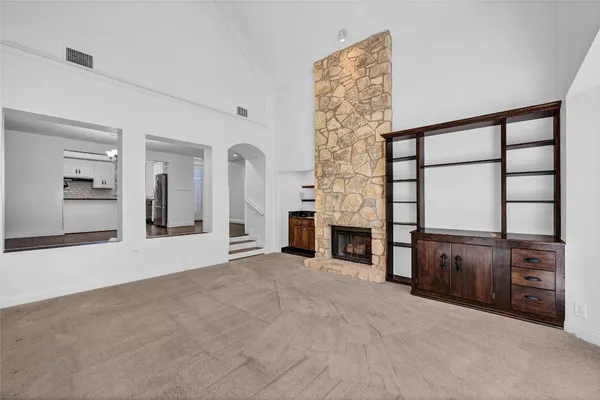 wooden floor in an empty room with a fireplace and window