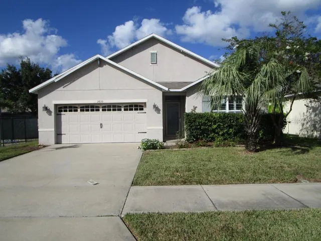a view of house with yard and a street