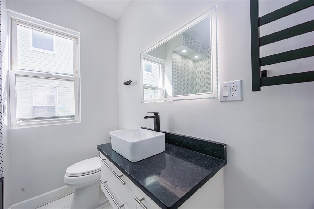40 Devon Street, Unit 1 Boston, MA 02121 - Photo 11 of 35 a bathroom with a sink toilet and mirror