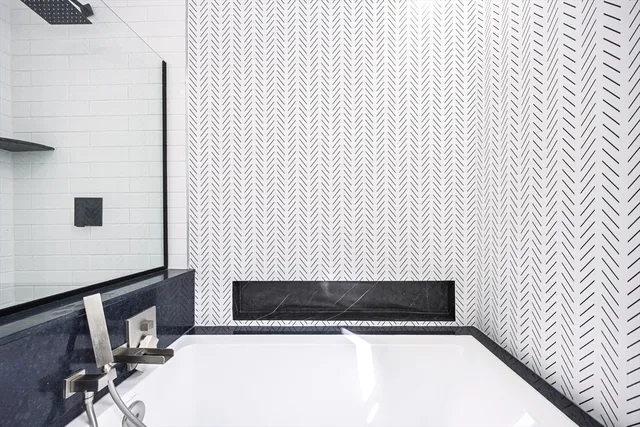 a bathroom with a sink a mirror and shower