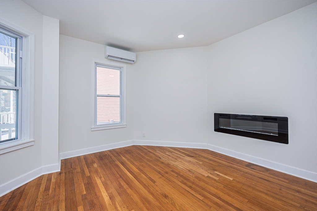 40 Devon Street, Unit 1 Boston, MA 02121 - Photo 17 of 35 an empty room with wooden floor and windows