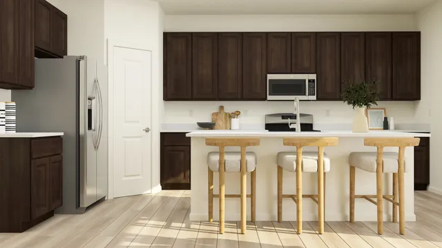 a kitchen with stainless steel appliances stove microwave refrigerator and cabinets