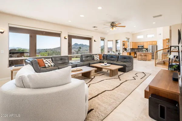 a living room with couches and kitchen view