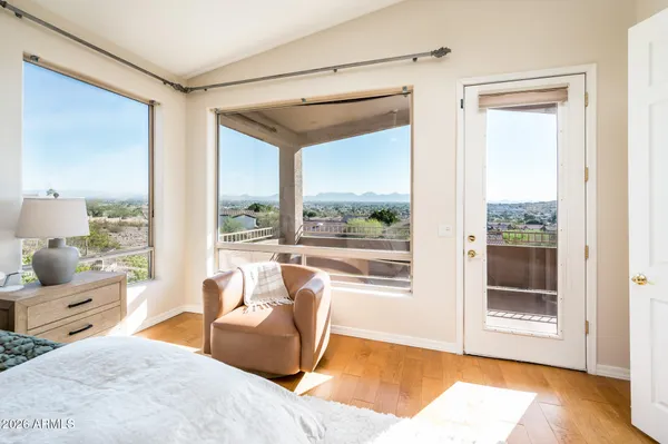 a bedroom with a bed and a flat tv screen