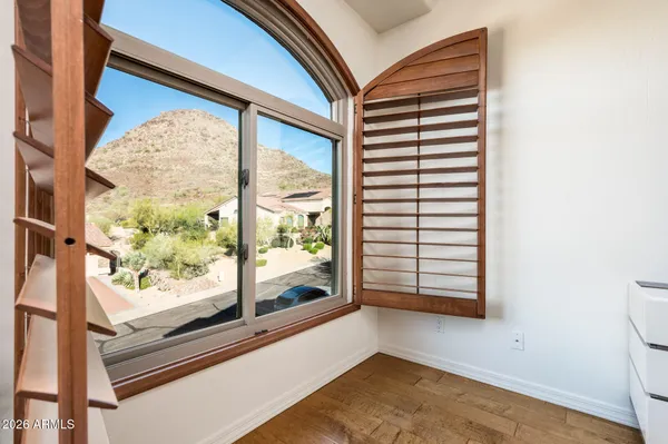 a spacious bedroom with a bed and a large window