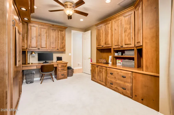 a living room with furniture cabinets and a window