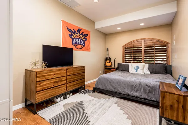 a bedroom with a bed and a flat screen tv