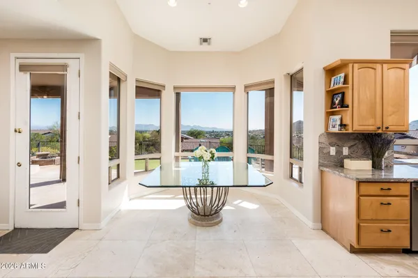 a living room with fireplace furniture and a large window