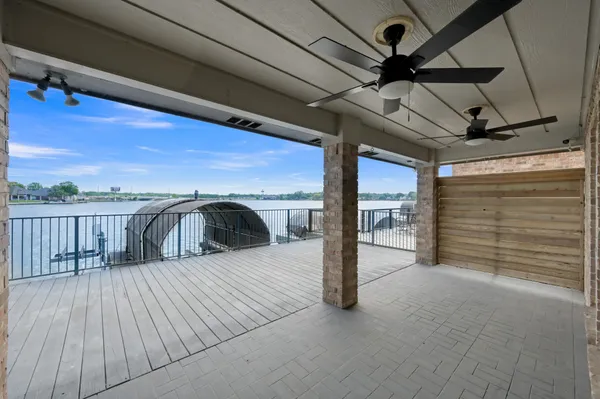 a view of a balcony with wooden floor and fence