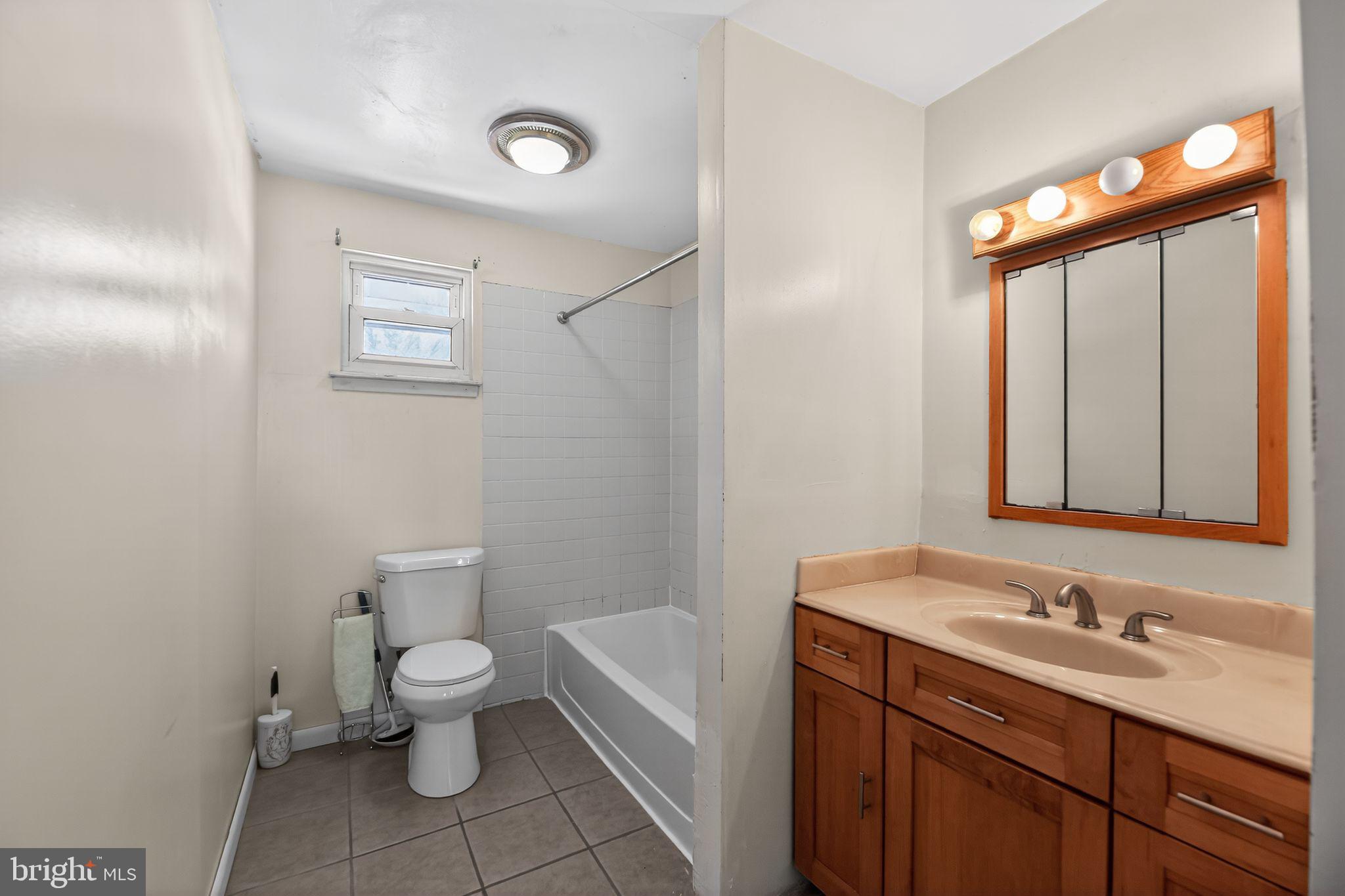308 Smith Lane Runnemede, NJ 08078 - Photo 14 of 32 a bathroom with a granite countertop sink a toilet and a mirror