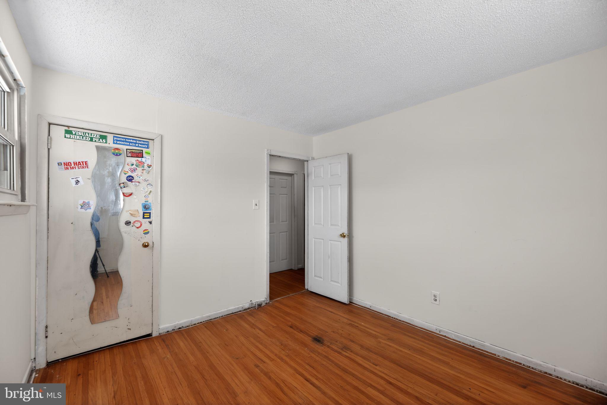 308 Smith Lane Runnemede, NJ 08078 - Photo 17 of 32 a view of an empty room with wooden floor and closet
