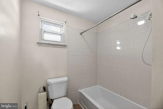 a bathroom with a sink mirror and toilet