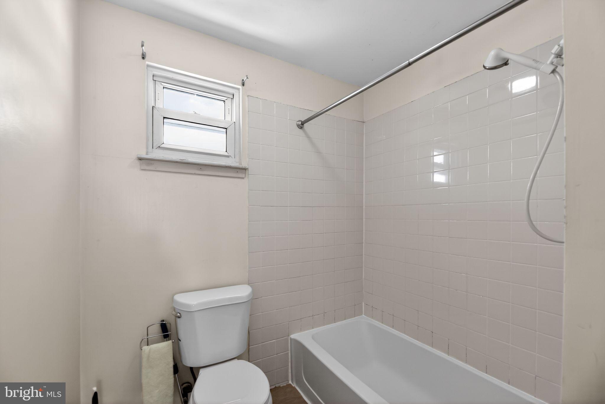 308 Smith Lane Runnemede, NJ 08078 - Photo 18 of 32 a white toilet sitting next to a bathroom sink and vanity
