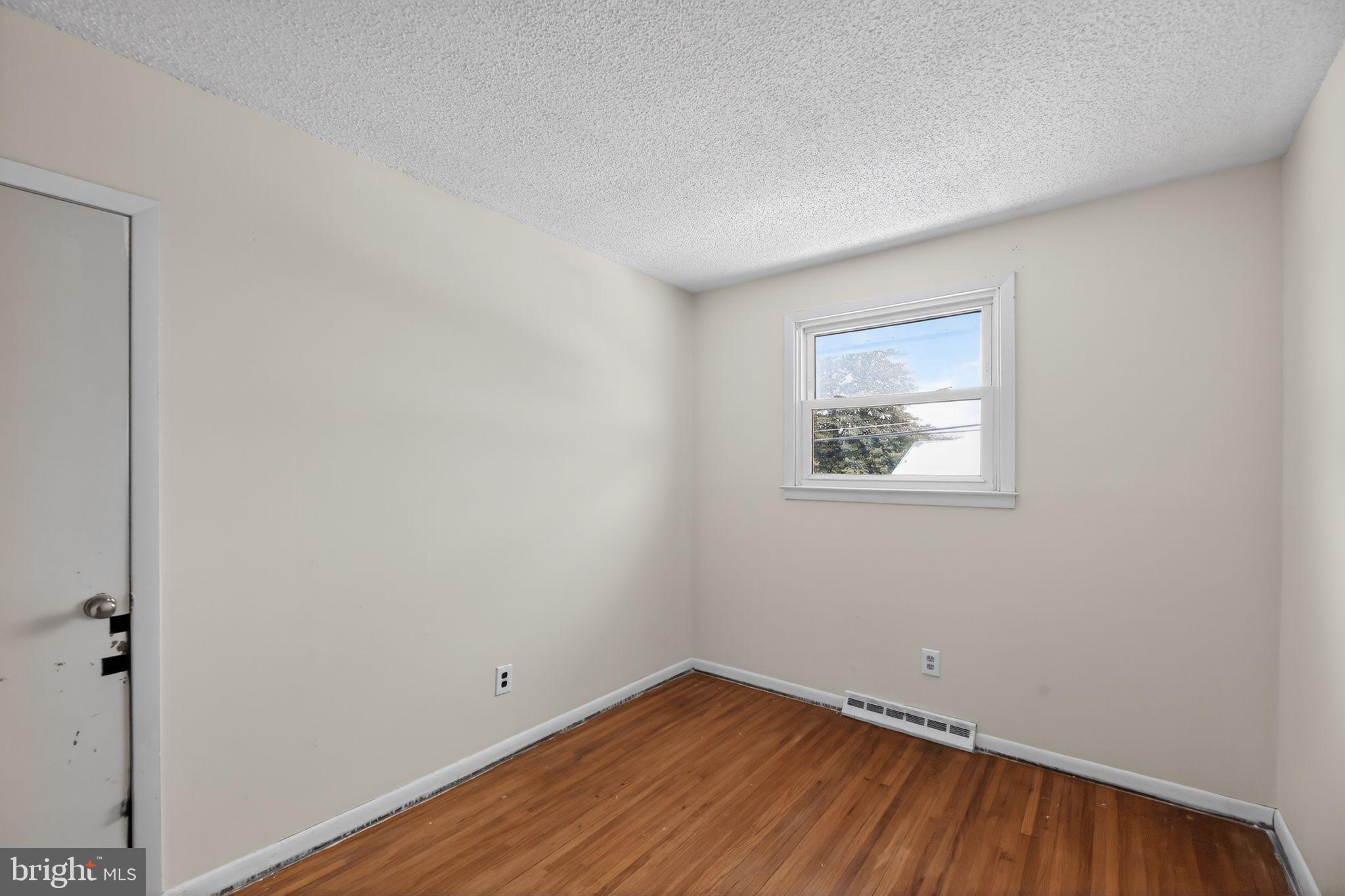 308 Smith Lane Runnemede, NJ 08078 - Photo 22 of 32 a view of an empty room with wooden floor and a window